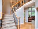 Welcoming foyer with hardwood floors, elegant staircase, and views into the living room at 1850 Noblin Ridge Way, Duluth, GA 30097