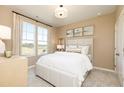 Cozy bedroom with soft, natural light from a large window dressed with elegant curtains and neutral toned walls at 610 Belshire Dr, Acworth, GA 30102