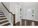 Bright foyer with hardwood floors, staircase, and natural light streaming through the window at 614 Denali Dr, Mableton, GA 30126