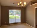 Dining room featuring a large window and neutral walls, offering a serene space for Gathering meals at 5415 Windcrest Ln, Suwanee, GA 30024