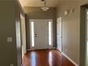 Inviting entryway with hardwood floors, a white front door, and neutral paint, creating a warm welcome at 5415 Windcrest Ln, Suwanee, GA 30024