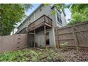 The unit has a private balcony overlooking a fenced backyard space at 1154 Village Se Ct, Atlanta, GA 30316