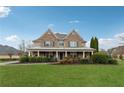 Inviting home with a well-manicured lawn and a welcoming covered front porch at 1527 Sage Ridge Dr, Marietta, GA 30064