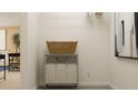 Well-organized laundry area with storage basket, shelving, neutral paint and decor at 2477 Cotton Ln, Douglasville, GA 30135