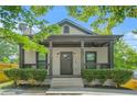 Charming home with mature trees and a covered front porch, perfect for enjoying the outdoors at 556 Paines Nw Ave, Atlanta, GA 30318