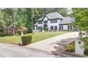 Elegant two-story home featuring a well-manicured lawn and a paved driveway at 1887 Chedworth Ct, Stone Mountain, GA 30087