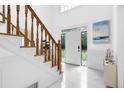 Bright foyer showcasing a staircase and elegant front door with decorative glass at 1887 Chedworth Ct, Stone Mountain, GA 30087