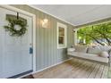 View of front porch with hanging swing and front door with wreath at 111 Marona Street Ne Ne St, Atlanta, GA 30307