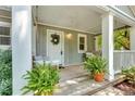 View of a covered front porch with hanging swing, plants, and room for seating at 111 Marona Street Ne Ne St, Atlanta, GA 30307