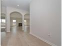Inviting home foyer with hardwood floors, arched doorways leading to a living room, and neutral paint tones at 494 Charleston Pl, Villa Rica, GA 30180