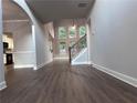 Spacious living room featuring hardwood floors, high ceilings, and a wall of windows overlooking the backyard at 4990 Arbor View Nw Pkwy, Acworth, GA 30101