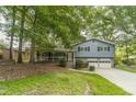 Traditional home with an inviting front porch, mature trees, and a two-car garage at 1348 Branchwood Dr, Snellville, GA 30078