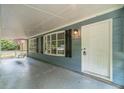 Inviting front porch featuring a white front door and decorative black shutters at 1348 Branchwood Dr, Snellville, GA 30078