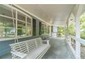 Relaxing front porch featuring a porch swing and white railing at 1348 Branchwood Dr, Snellville, GA 30078