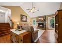 Inviting living room with hardwood floors, stone fireplace, and plenty of natural light at 2208 Mountain Springs Nw Ct, Kennesaw, GA 30144