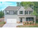 Charming two-story home showcasing gray siding, black shutters, and a welcoming front porch at 496 Charleston Pl, Villa Rica, GA 30180