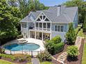 Aerial view of a private backyard with a pool, spa, patio, and well-maintained landscaping at 2429 Kirk Nw Ln, Kennesaw, GA 30152