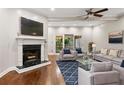 Bright living room with hardwood floors, fireplace, comfortable seating, and sliding doors to the outside at 6 Alston Place Ne Ne Pl, Atlanta, GA 30324