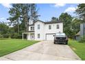 Charming two-story home featuring a covered porch, attached garage, and well-manicured lawn at 2670 Trotters Pointe Drive Dr, Snellville, GA 30039