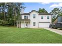 Charming two-story home featuring a covered porch, attached garage, and well-manicured lawn at 2670 Trotters Pointe Drive Dr, Snellville, GA 30039
