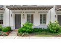 Charming townhome with white brick, a gray door, and a well-manicured front garden at 328 Stonemont Dr, Atlanta, GA 30305