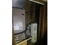 Compact utility room housing water heater and HVAC unit with visible wiring at 6354 Shannon Pkwy # 12D, Union City, GA 30291