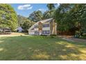 Well-maintained two-story home with an attached two-car garage and a large lawn at 2505 Hamilton Parc Ln, Buford, GA 30519