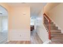 Inviting entryway features wood-look flooring, wainscoting, and staircase at 3019 Iona Ct, Snellville, GA 30039