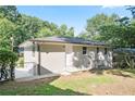 Fenced backyard with freshly painted one-story home and chain link fencing for added security at 3436 Adkins Nw Rd, Atlanta, GA 30331