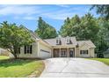 Single-story home with a two-car garage, manicured lawn, and inviting stone-accented entryway at 114 Arborwood Way, Temple, GA 30179