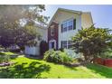 Well-maintained two-story home featuring a lush lawn, mature trees, and a welcoming front entrance at 1273 Royal Ives Ct, Lawrenceville, GA 30045
