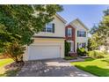 Two-story home with a attached garage, with brick and siding exterior and well-kept lawn at 1273 Royal Ives Ct, Lawrenceville, GA 30045