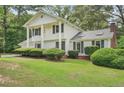 Charming two-story home boasting lush green lawn, mature landscaping, and inviting curb appeal at 1651 King Rd, Riverdale, GA 30296