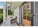 Cozy covered porch with seating area, offering a welcoming entrance with a wooden and glass front door at 1651 King Rd, Riverdale, GA 30296