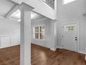 Bright foyer showcasing hardwood floors, elegant columns, and wainscoting detail at 149 Elkins Blvd, Locust Grove, GA 30248