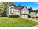 Beautiful suburban home with lush green lawn and lovely landscaping on a sunny day at 11739 Sawgrass Ct, Fayetteville, GA 30215