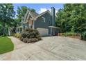 Charming two-story home showcasing a two-car garage and well-manicured landscaping at 4020 High Gables E, Cumming, GA 30041