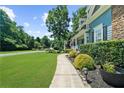 Charming two-story home with manicured lawn, lush landscaping, and inviting walkway at 4020 High Gables E, Cumming, GA 30041