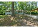 Inviting single-story home featuring a light blue painted brick facade, and a covered carport at 506 Bolijeri Blvd, Villa Rica, GA 30180