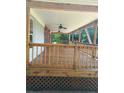 Spacious covered porch with natural wood railings and ceiling fans, perfect for outdoor relaxation and entertaining at 393 W Freeman St, Maysville, GA 30058
