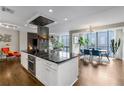 Spacious kitchen with black countertops, a central island, and an open layout to the dining area at 145 15Th Ne St # 826, Atlanta, GA 30309