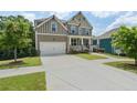 Beautiful front view of a two-story home featuring a large driveway and manicured lawn at 1618 Chancery Ln, Lithia Springs, GA 30122