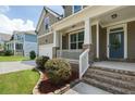 Close-up of a charming front porch with white railings and a blue front door at 1618 Chancery Ln, Lithia Springs, GA 30122