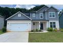 Charming two-story home with a gray roof, white brick, and a two-car garage at 4234 Freight St, Tucker, GA 30084