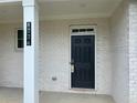 Inviting front entrance with a classic black door, a white brick surround, and a clear address at 4234 Freight St, Tucker, GA 30084