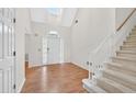 Bright foyer with hardwood floors, staircase, and natural light from the window above the front door at 2866 Wynford Sw Dr, Marietta, GA 30064