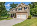 Beautiful two-story home with a two-car garage, covered porch, and lush green lawn at 4160 Radford Oaks Ln, Cumming, GA 30028