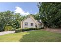 View of the front yard and home with lush green lawn and mature trees, showcasing its curb appeal at 629 Pine Ter, Canton, GA 30114
