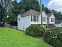 Side view of a charming two-story home with white siding and well-maintained landscaping at 4192 Rhinehart Dr, Austell, GA 30106
