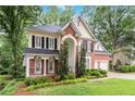Beautiful two-story home with a well-kept lawn and mature trees providing a serene backdrop at 2200 Major Loring Sw Way, Marietta, GA 30064